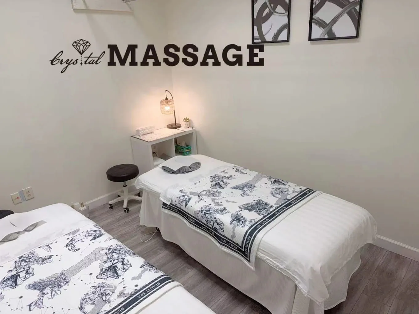 Treatment table made up with fresh linen in a curtained massage room at Crystal Massage, Wichita