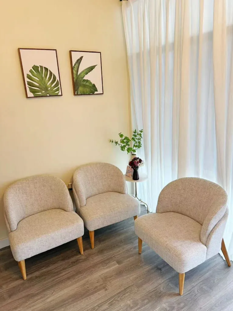 Armchairs beside a curtained window in the Crystal Massage waiting area